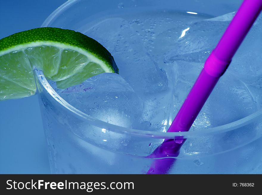 Ice cold beverage with lime and straw. Ice cold beverage with lime and straw.