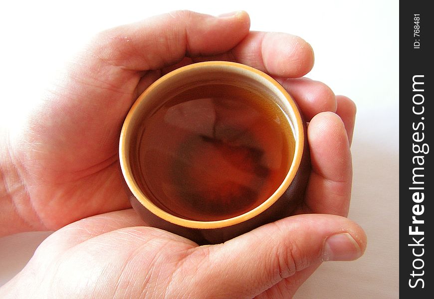 Hands holding an Asian teacup
