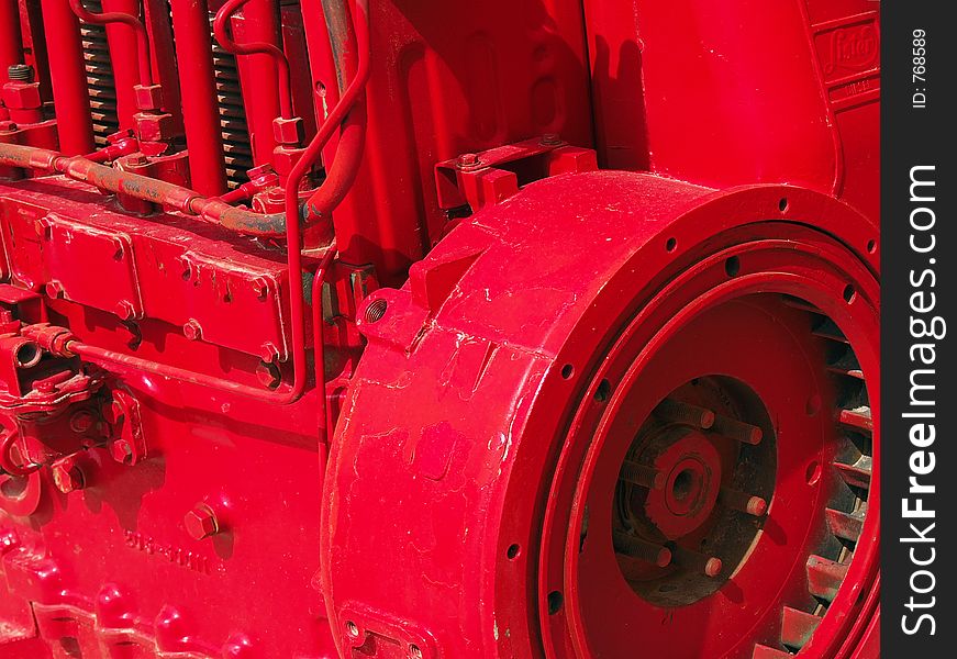 Bright red painted industrial engine with flywheel and valve springs showing. Bright red painted industrial engine with flywheel and valve springs showing.