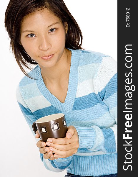 A pretty young asian woman holding a brown mug. A pretty young asian woman holding a brown mug
