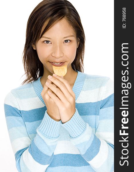 A pretty asian woman holding a chip. A pretty asian woman holding a chip