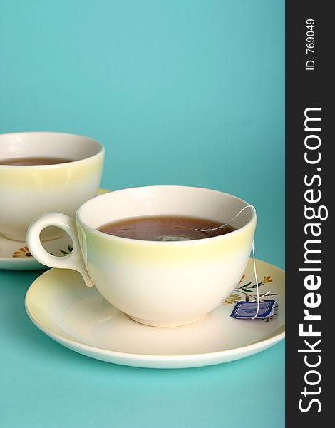 Vertical version of vintage teacups with teabag string, fresh color scheme. Vertical version of vintage teacups with teabag string, fresh color scheme