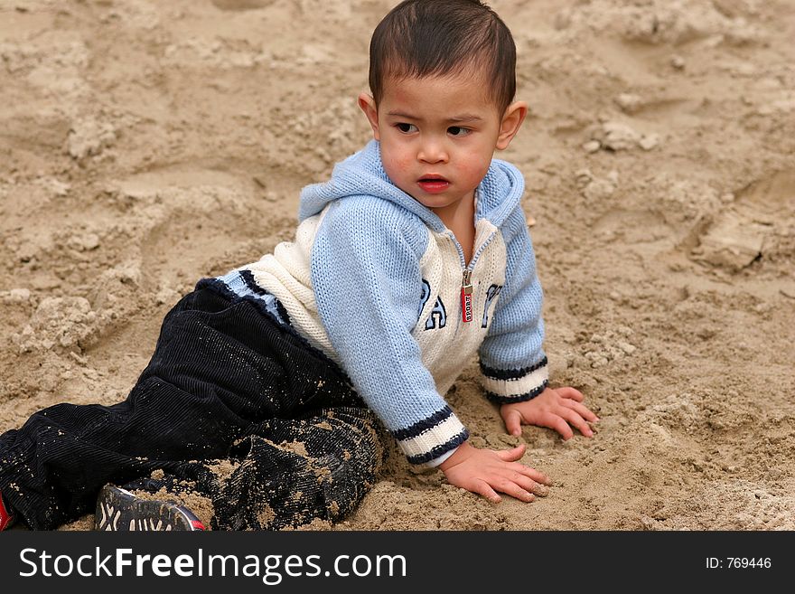 Asian child playing in sand. Asian child playing in sand
