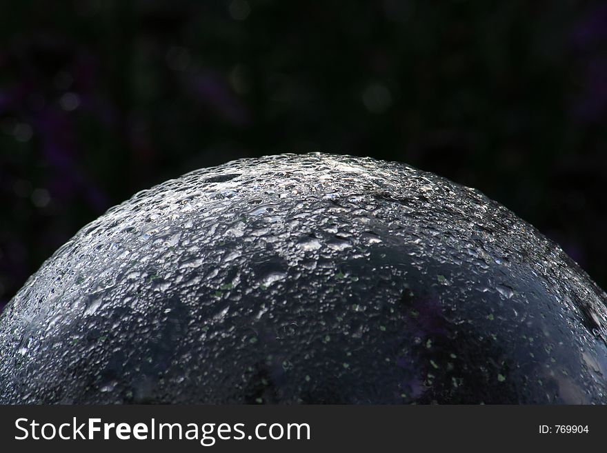 A glass globe covered in rain drops. A glass globe covered in rain drops.