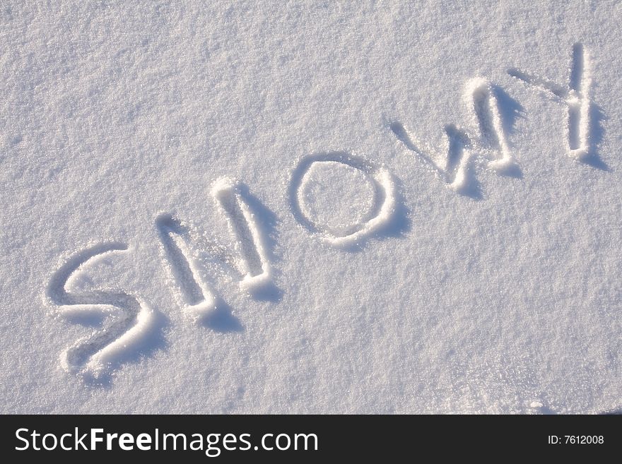 Writing text SNOWY in sunny day on the snow