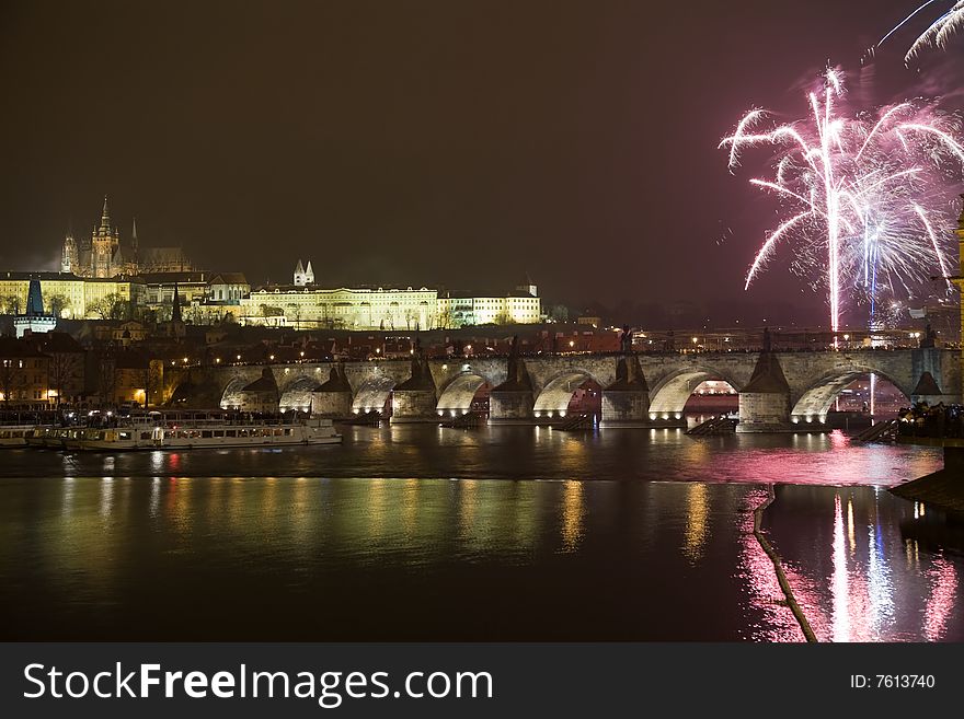 New Year 2009 celebration with fireworks in Prague above Charles bridge and Prague castle in the background.