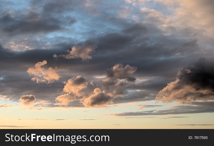 Natural photo of the sky,evening, summer, northern hemisphere. High plumose clouds are visible. Windy weather.