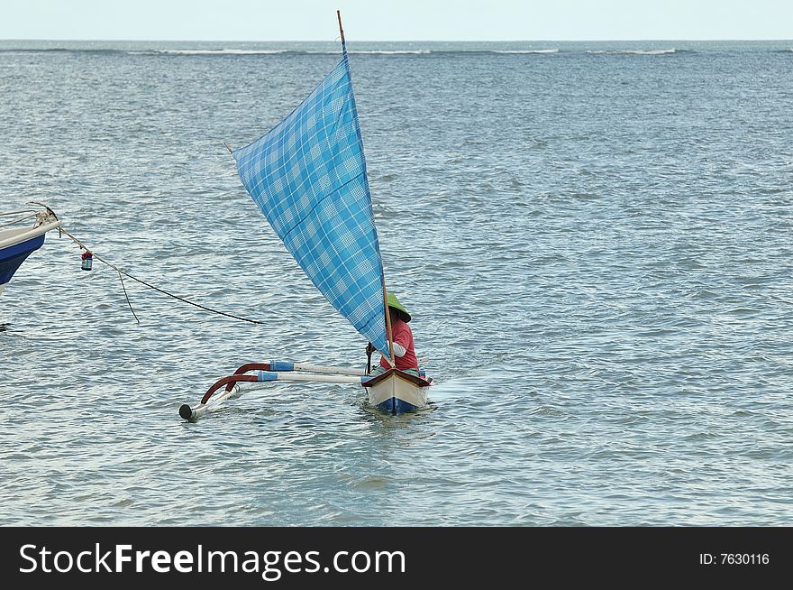 Fisherman returns to the beach. Sanur, Bali, Indonesia. Fisherman returns to the beach. Sanur, Bali, Indonesia