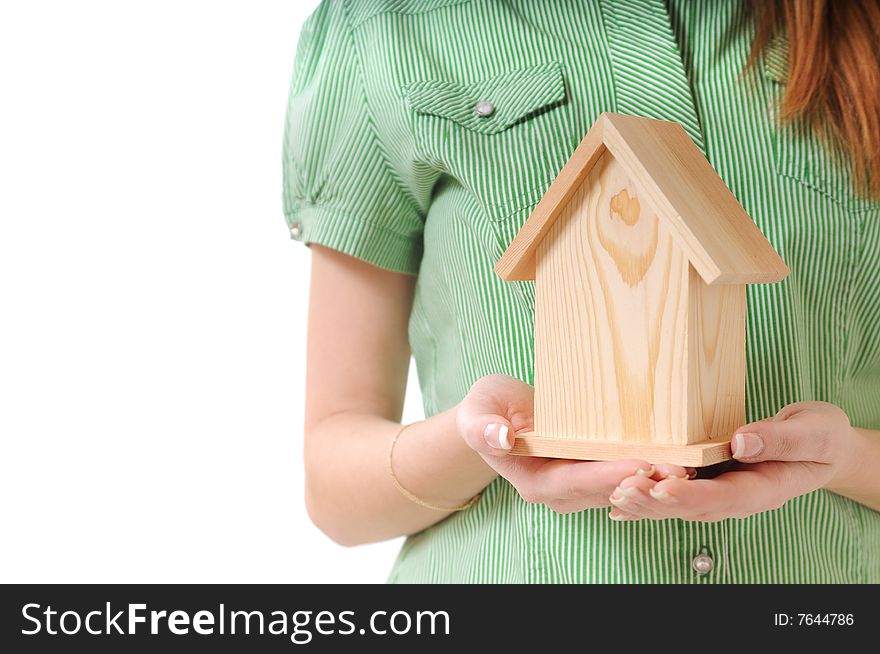 Little home in the hands of young woman, on the white background