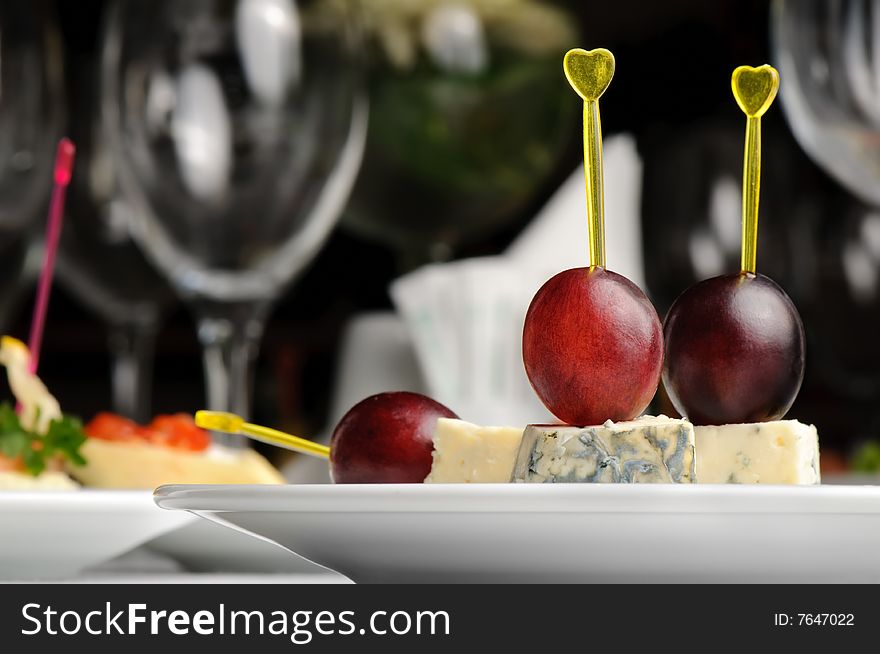 Canape with Roquefort cheese and grape berry, served at restaurant table