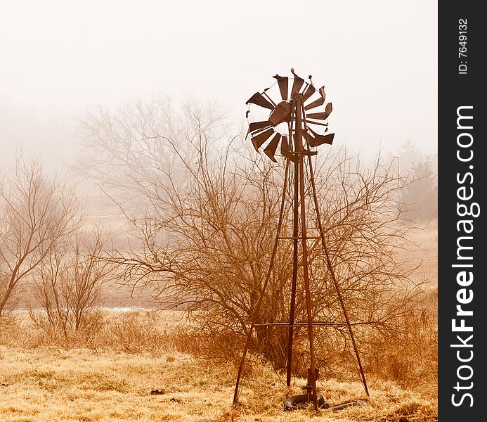 Old windmill shrouded by fog. Old windmill shrouded by fog