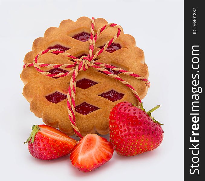 Stack of cookies with jam and strawberries on white background