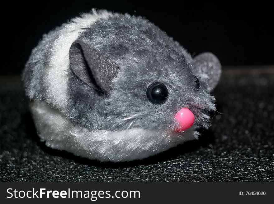 Cute fluffy grey mouse toy for cats close up.