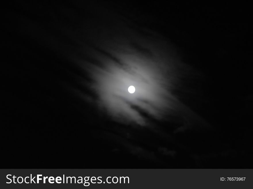 Black and white photo of the moon and clouds. Black and white photo of the moon and clouds