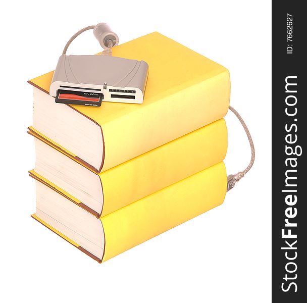 Yellow hardback books with a compact flash card reader isolated on a white background