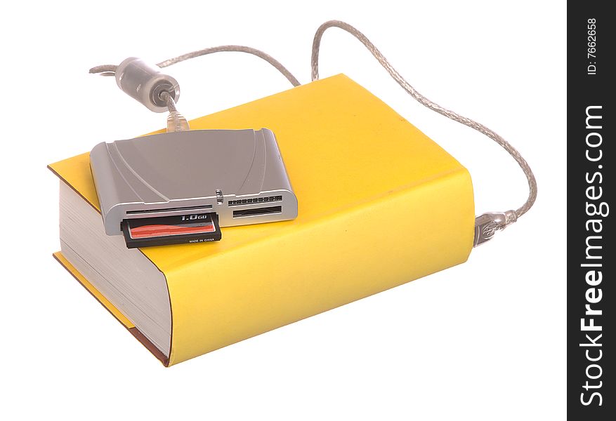 Yellow hardback books with a compact flash card reader isolated on a white background