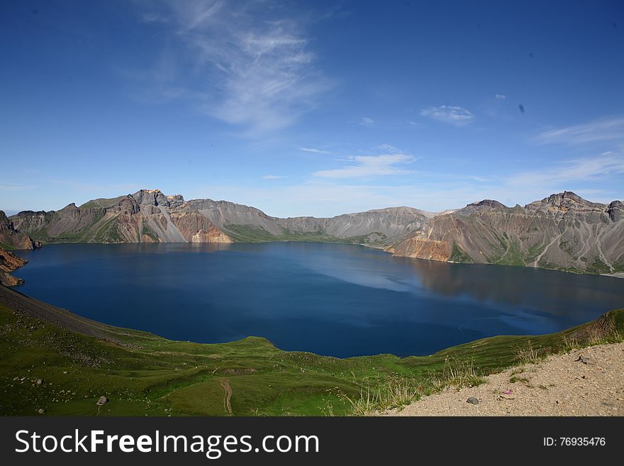 The famous view of Changbai Moutain. Tianchi lake is on the top of Changbai Mountain that formed in the crater of a huge volcano - Changbai Mountail. The water of lake is blue, it's always covered by frag, so it's lucky if you could see her beautiful view. The famous view of Changbai Moutain. Tianchi lake is on the top of Changbai Mountain that formed in the crater of a huge volcano - Changbai Mountail. The water of lake is blue, it's always covered by frag, so it's lucky if you could see her beautiful view.