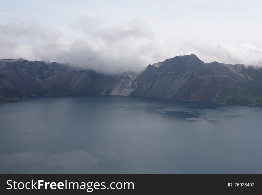 The famous view of Changbai Moutain. Tianchi lake is on the top of Changbai Mountain that formed in the crater of a huge volcano - Changbai Mountail. The water of lake is blue, it's always covered by frag, so it's lucky if you could see her beautiful view. The famous view of Changbai Moutain. Tianchi lake is on the top of Changbai Mountain that formed in the crater of a huge volcano - Changbai Mountail. The water of lake is blue, it's always covered by frag, so it's lucky if you could see her beautiful view.