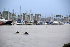 Surfers Paddling Through Boat Harbor Jetty Stock Photography Surfers Paddling Through Boat Harbor Jetty Stock Photography