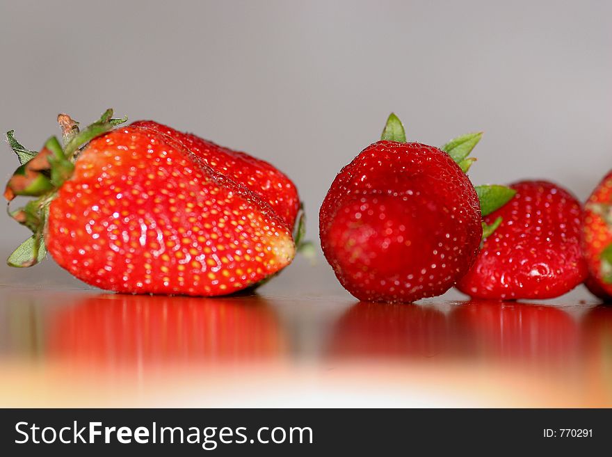 Ripe strawberries laying on a table. Ripe strawberries laying on a table