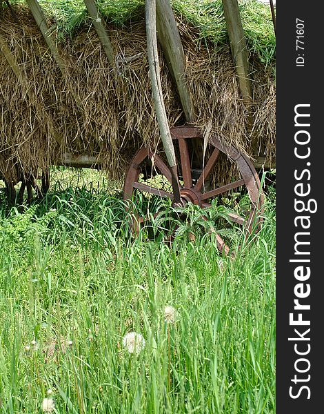 Old-time, rustic vehicle in field. Old-time, rustic vehicle in field