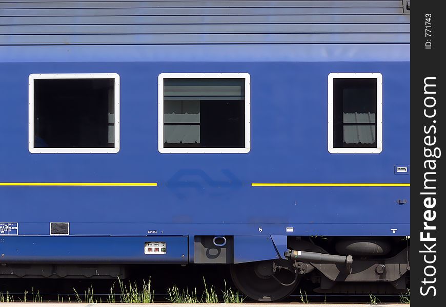 Blue coloured railway waggon with three windows. Blue coloured railway waggon with three windows