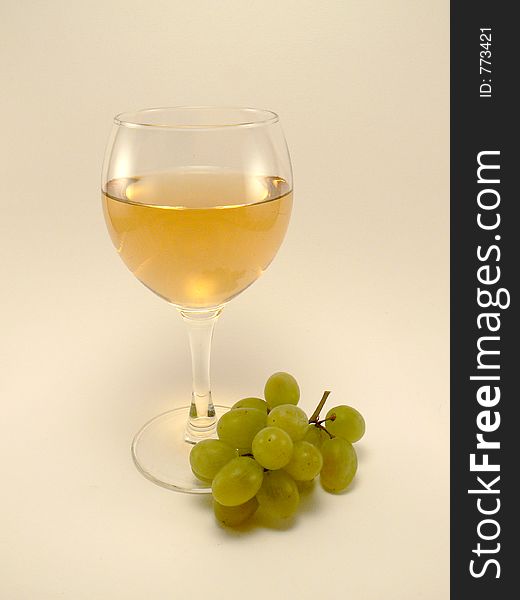 White wine with grape and light yellow backgroung