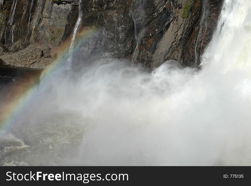 A rainbow at the foot of Montmorency Falls, Quebec. A rainbow at the foot of Montmorency Falls, Quebec.