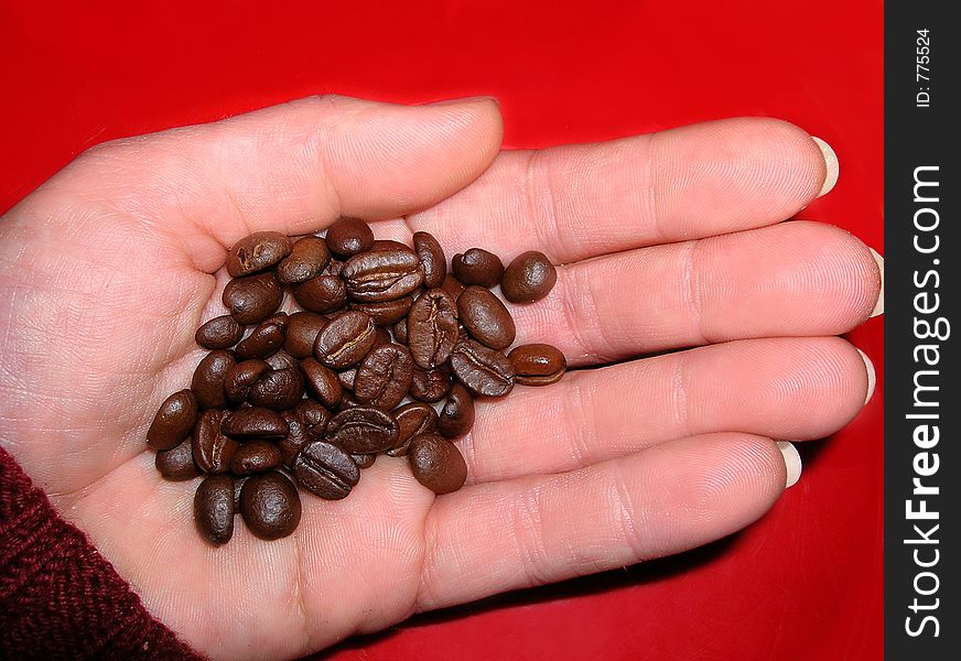 Coffee in the hand at red background