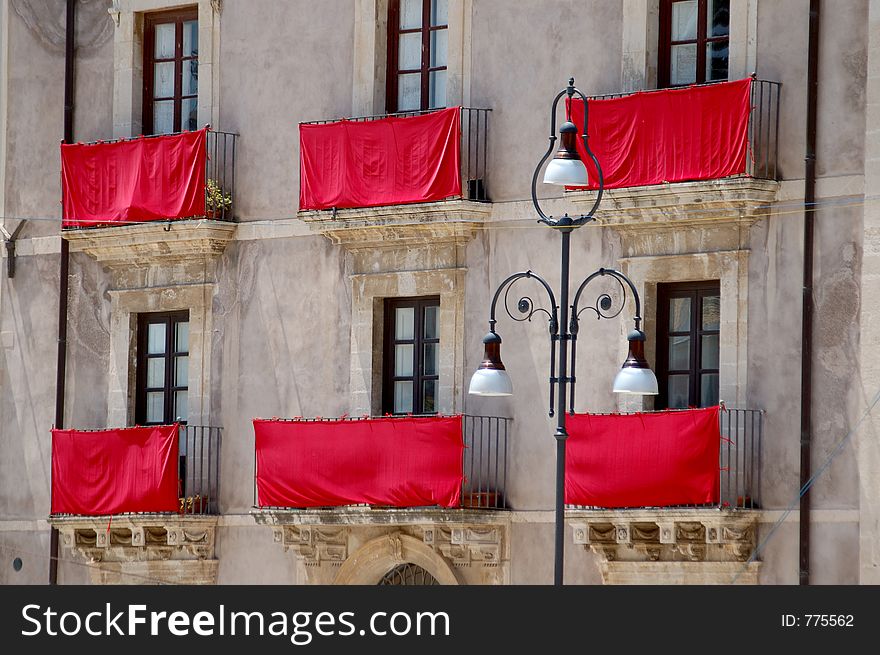 Red drapes on an ancient facade