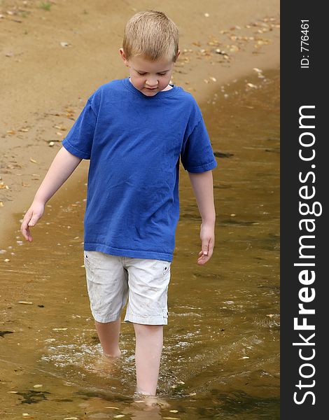 A child wading in a lake.