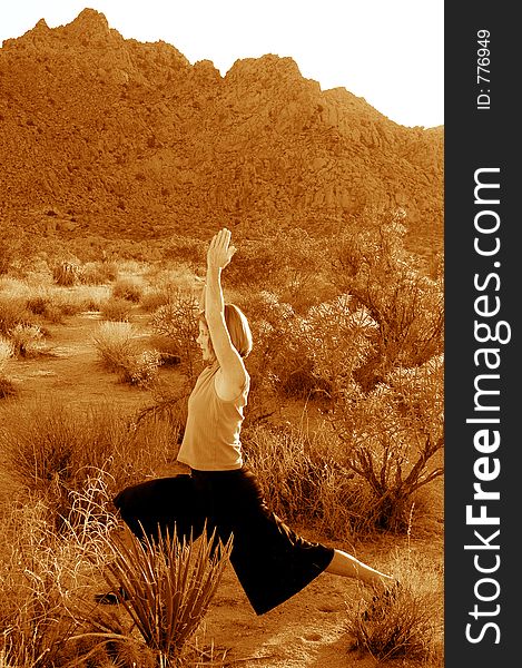 Toned black and white image of woman practicing yoga in the desert. Toned black and white image of woman practicing yoga in the desert.