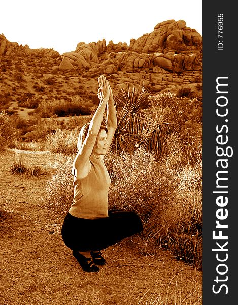 Senior woman practicing yoga at dusk in the desert. Senior woman practicing yoga at dusk in the desert.