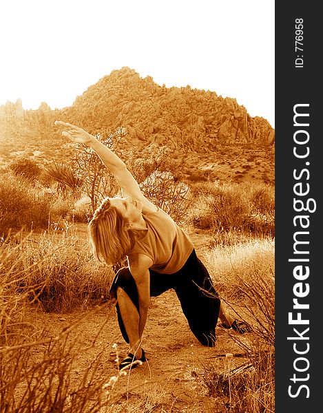 Senior woman practicing yoga during dusk in the desert. Senior woman practicing yoga during dusk in the desert.