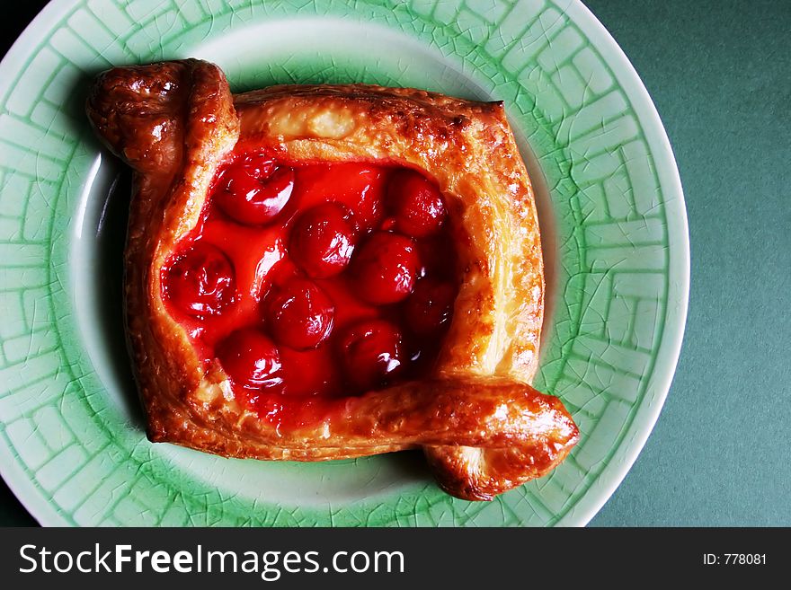 Cherry pastry on a green plate