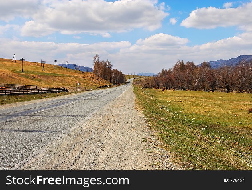 Road, mountains and skies. Russi, Altay.