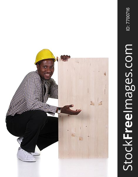 Young african american carpenter holding wooden plank on white background