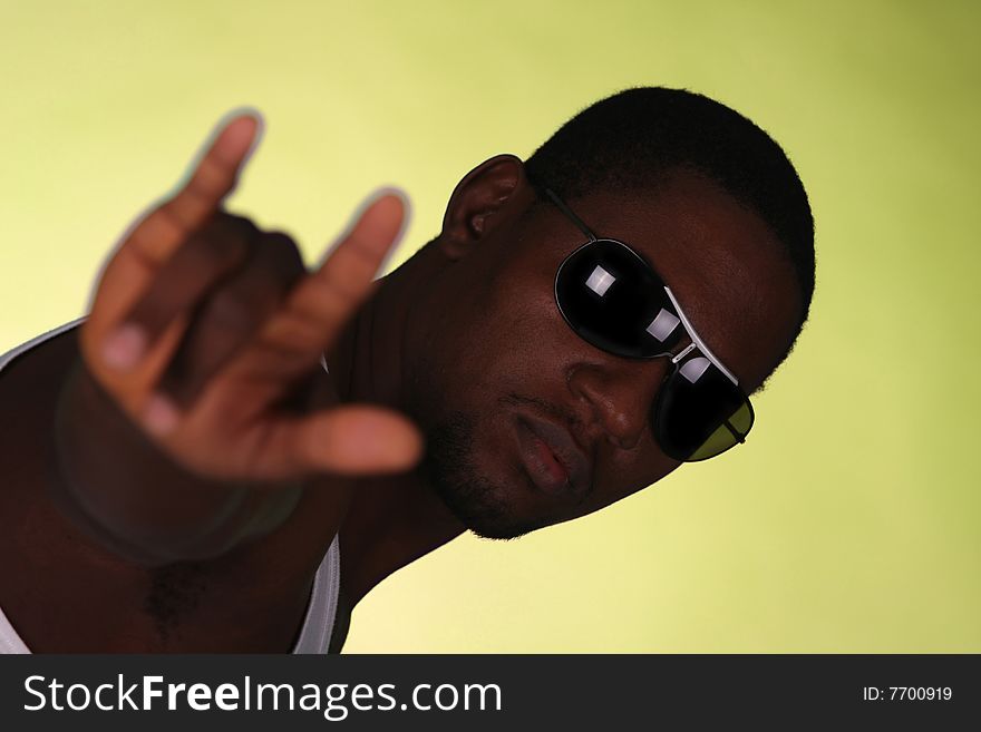 Young african american male on yellow background