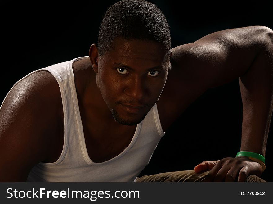 Young african american male on black background