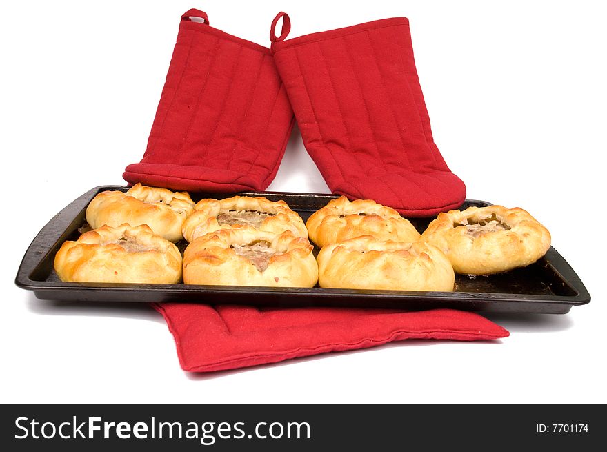 Round fried meat pies on baking tray on white background. Round fried meat pies on baking tray on white background