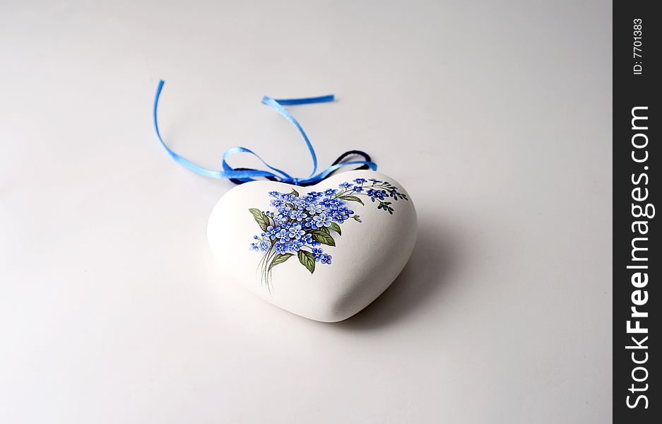 Porcelain heart with floral image glued over