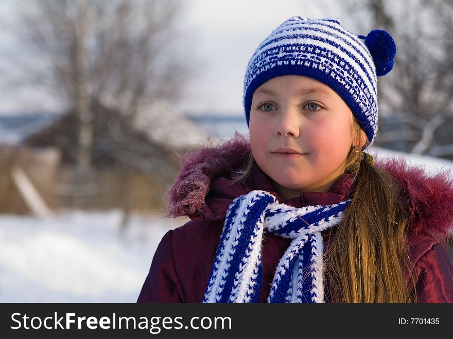 Little girl is in a dark blue scarf and cap