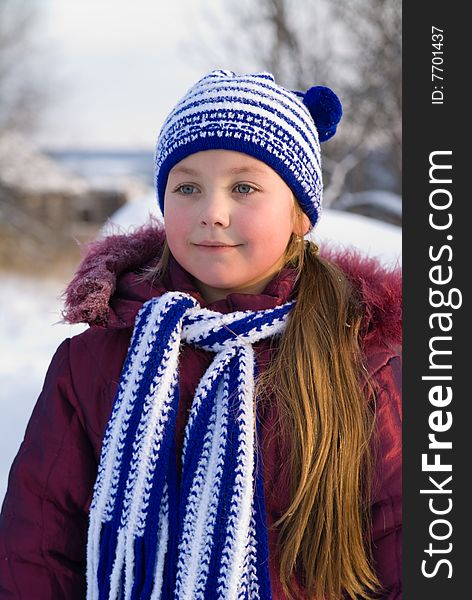 Little girl is in a dark blue scarf and cap