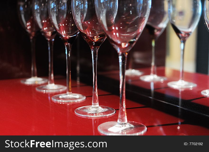 Several glass cups on red table