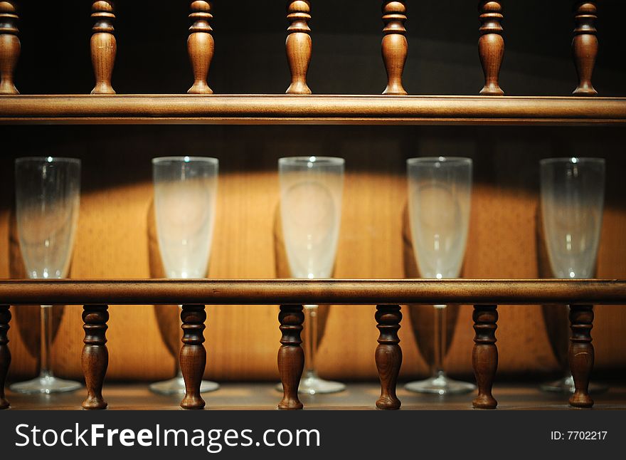Five glass cups in wooden closet. Five glass cups in wooden closet