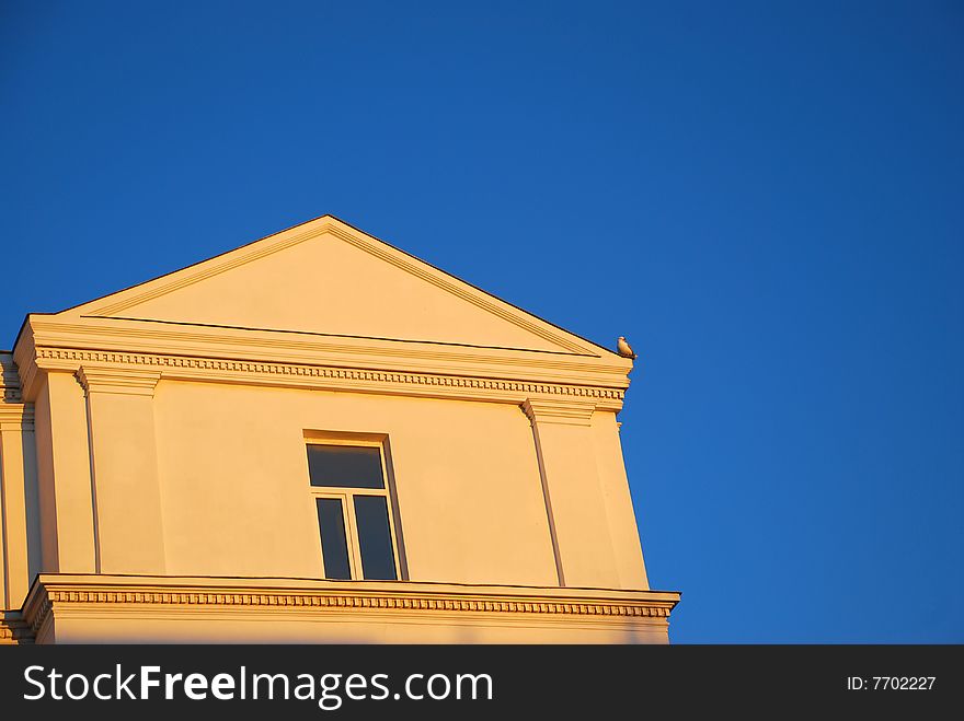 Part of a building standing against blue sky