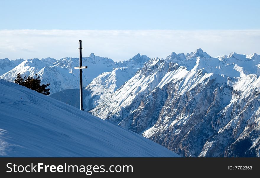 Winter mountains view with cross facing mountains. Winter mountains view with cross facing mountains