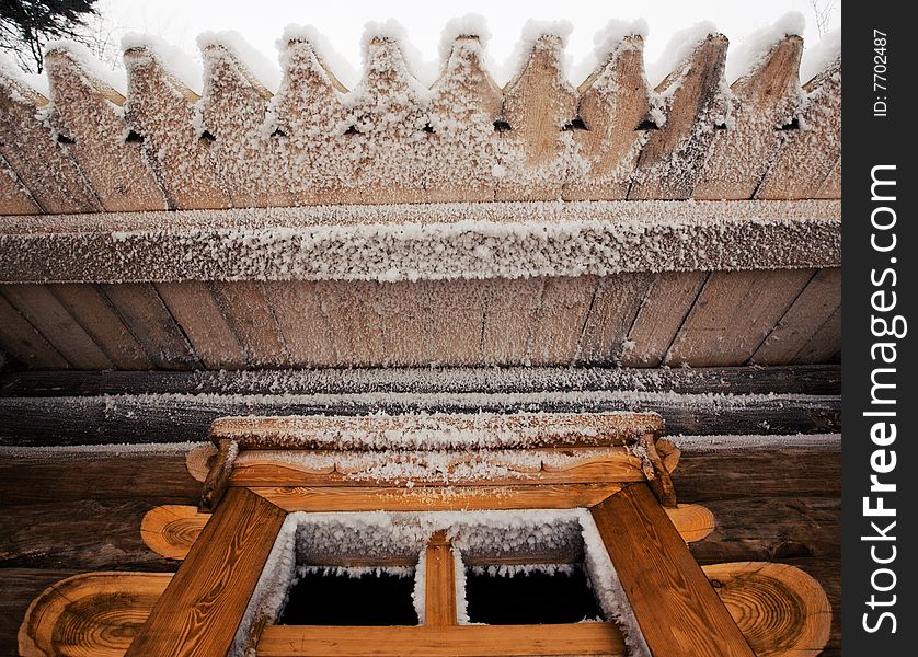 Wooden house roof and window covered with snow. Wooden house roof and window covered with snow