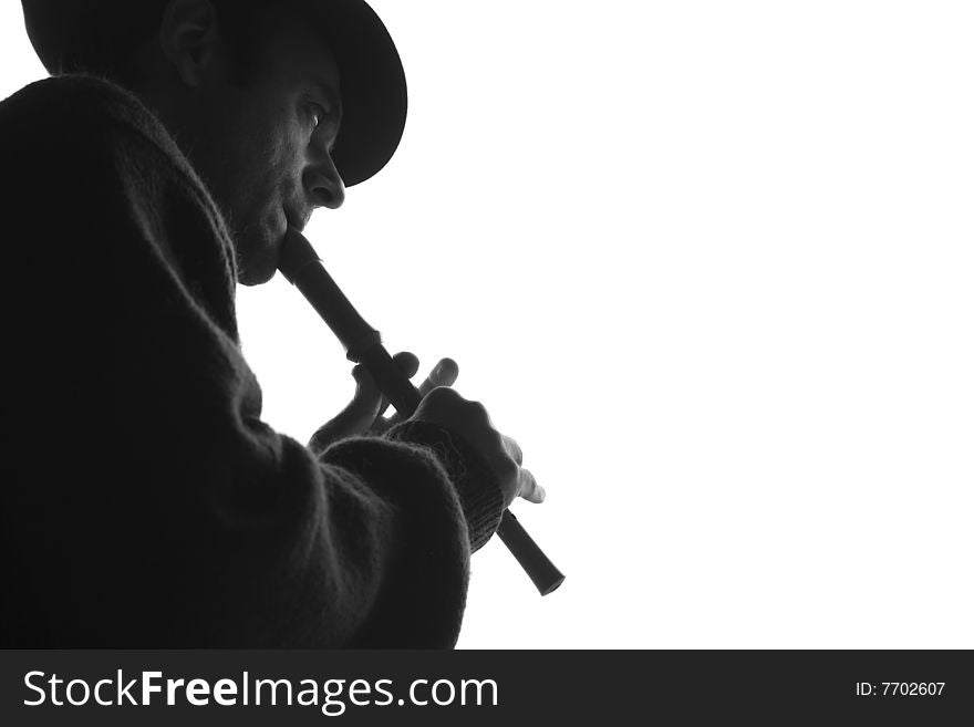 A man playing flute outdoor. A man playing flute outdoor