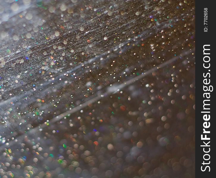 Scratched glass with water drops macro